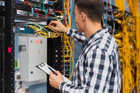 Engineer at a network rack